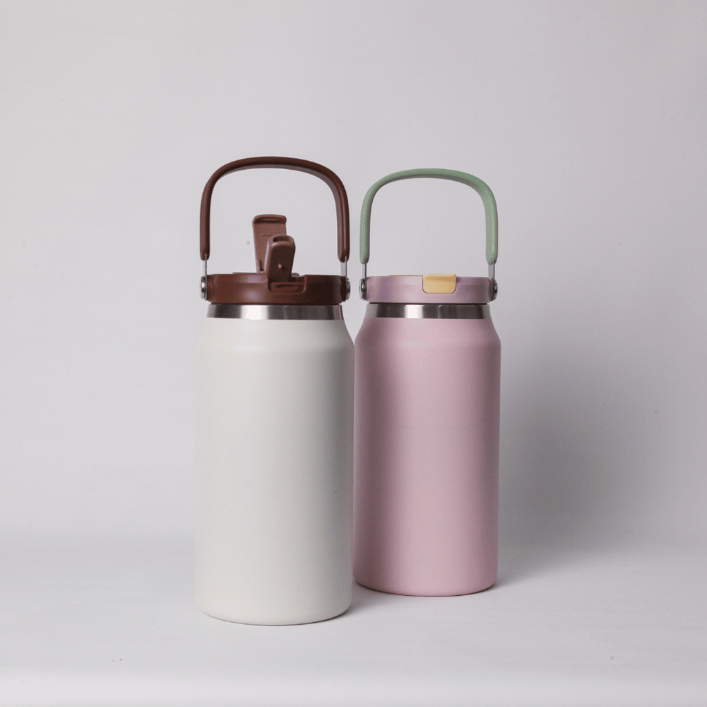 Two Mizzu insulated bottles, one white and one pink, with brown and green lids on a light gray background.