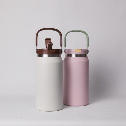 Two Mizzu insulated bottles, one white and one pink, with brown and green lids on a light gray background.